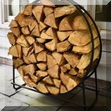 L03. Iron log holder and firewood. 